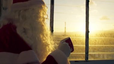 Noel Baba gün batımında bir fincan kahvenin tadını çıkarıyor.. 