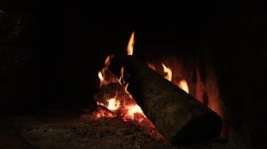 Winter bonfire.Cozy fire or fireplace in a village house. Wood of holm oak and olive tree. 