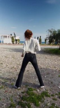 Sahilde kendini dansla ifade eden kadın