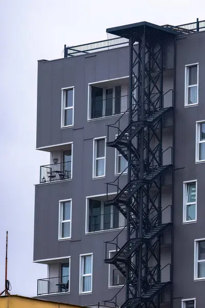 Exterior iron stairs on a multi-story residential building.