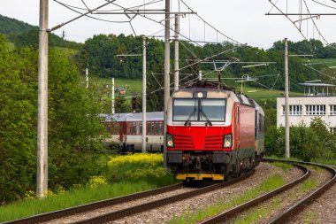 Slovakya 'da elektrikli bir demiryolunda seyahat eden bir yolcu treni..