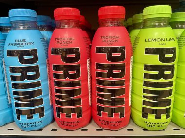 Prague, Czech Republic - January 9, 2024: Blue, red and green plastic bottles of Prime, the energy drink infamous for its extremely high caffeine content and advertising aimed at children. High