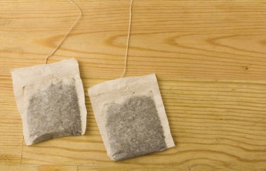 Teabag Isolated on wooden background. clipart