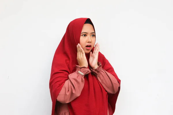 Beautiful Asian hijab woman surprised looking to empty space, isolated on white background