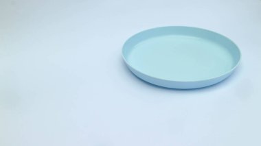 Beyaz arkaplanda izole edilmiş mavi boş plastik plakalar