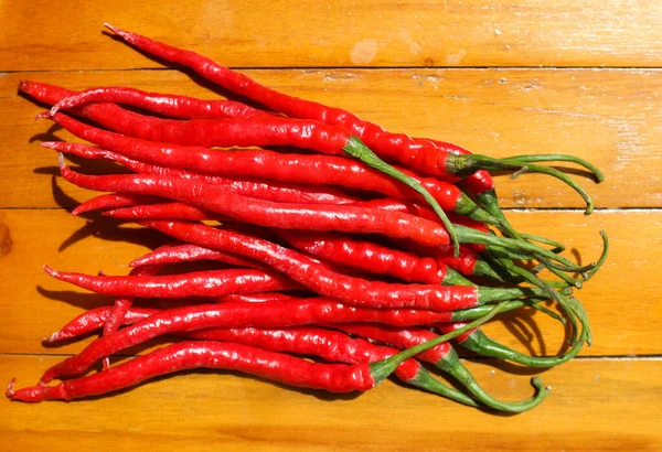 Cabe or cabai merah keriting (red curly chili) is one of the most wanted chili varieties in Indonesia. It is very popular ingredients to make various Indonesian cuisines. Wooden background