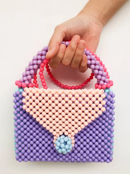 hand holding beads handbag, elegant and cute to wear