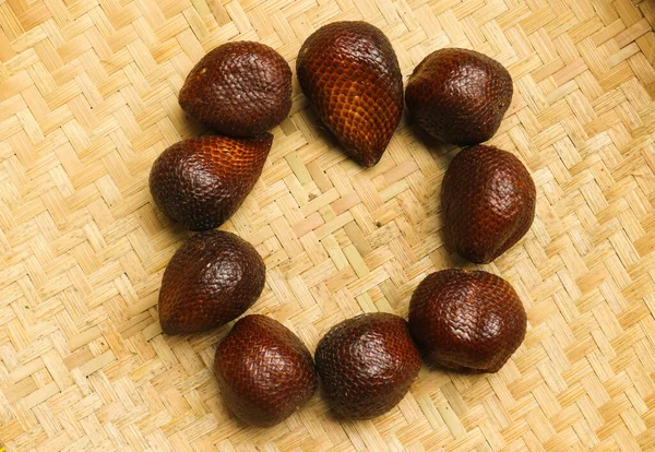 Salak or snake fruit. Group of Salak on woven background