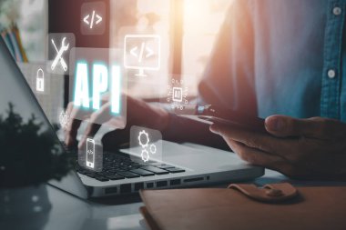 API - Uygulama Programlama Arayüzü, Ofis masasında VR ekran API simgesi olan dizüstü bilgisayar kullanan kadın, Yazılım geliştirme aracı, modern teknoloji, internet ve ağ konsepti.