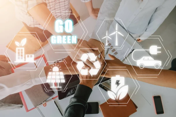 Go green renewable energy recycling zero waste ecology lean concept, Happy business team celebrating victory in office with VR screen Go green icon.
