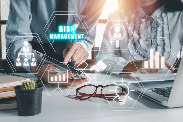 Risk management strategy plan finance investment internet business technology concept, Business team analyzing income charts and graphs with icons risk management on VR screen.