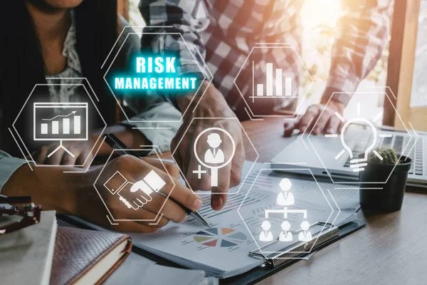 Risk management strategy plan finance investment internet business technology concept, Business team analyzing income charts and graphs with icons risk management on VR screen.