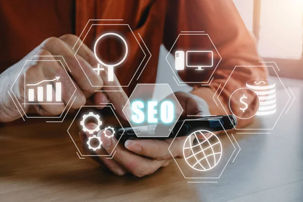 SEO Concept, Search Engine Optimization, Man hand using smart phone with VR screen seo icon, concept for promoting ranking traffic on website, optimizing your website to rank in search engines.