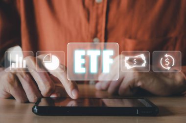 ETF Borsası hisse senedi borsası yatırım finansal konseptini takas etti, VR ekranında ETF simgeleri olan akıllı telefonu kullanan adam.