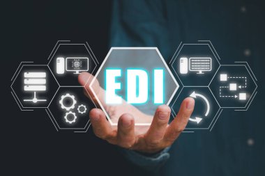 EDI, Electronic data interchange concept, Person hand holding Electronic data interchange icon on virtual screen.