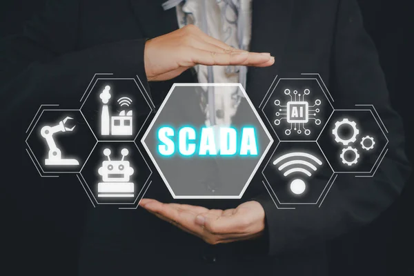 SCADA Supervisory control and data acquisition technology concept, Person hand holding SCADA icon on virtual screen.