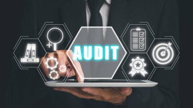 Audit Internal Financial Examination Accounting Business Finance concept, Businessman hand touching tablet conputer with audit icon on virtual screen,income statement, balance sheet, cash flow statement.