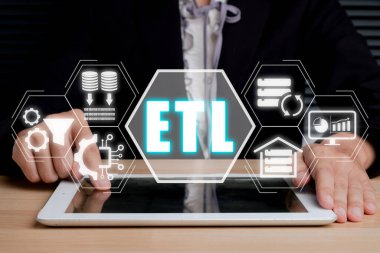 ETL extract transform load concept, Person using digital tablet with extract transform load icon on virtual screen.