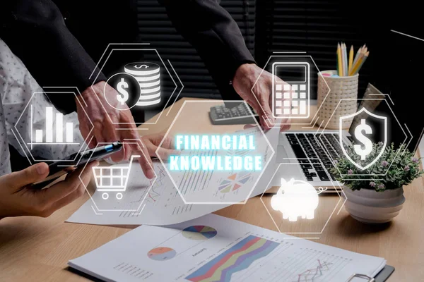 Financial knowledge concept, Business team analyzing income charts and graphs with financial knowledge icon on virtual screen.