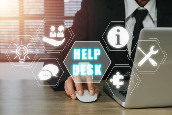 Communication Service Help Desk Concept, Person using laptop computer on office desk with Help desk icon on virtual screen.