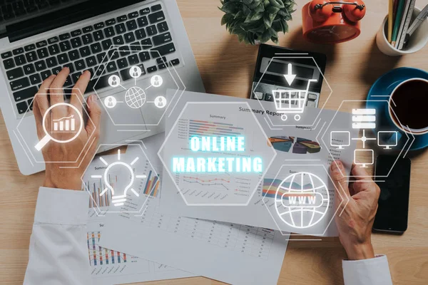 Online Marketing Advertisement Social Media Concept, Top view of Businessman analyzing business charts and graphs with online marketing icon on virtual screen.