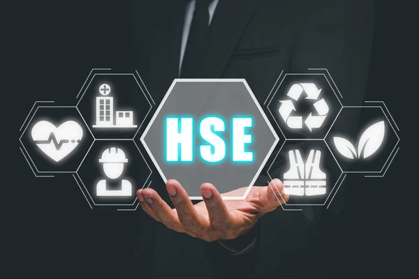 Health safety environment, HSE education industry Concept, Man hand holding health safety environment icon on virtual screen.