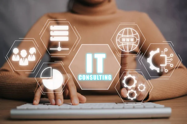 Consulting business concept, Person hand using keyboard computer with IT Consulting icon on virtual screen, robotic process automation, marketing dashboard.