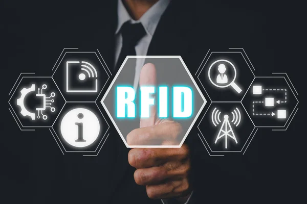 RFID, Radio frequency identification concept, Businessman hand touching Radio frequency identification icon on virtual screen.