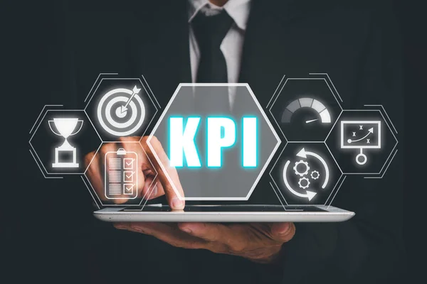 KPI, Key performance indicator business and industrial analysis concept, Person using digital tablet with Key performance indicator icon on virtual screen.