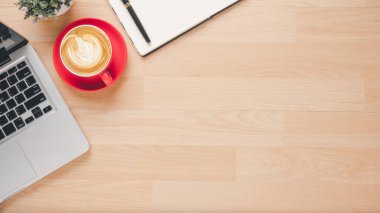 Office desk workplace with laptop computer, pen, notebook and cup of coffee, Top view flat lay with copy space.