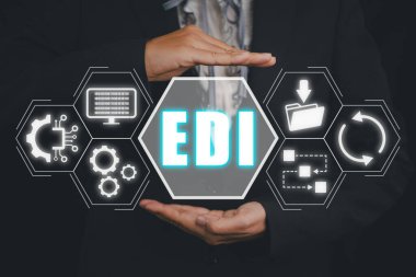 EDI, Electronic data interchange concept, Person hand holding Electronic data interchange icon on virtual screen.
