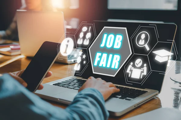Job fair concept, Person using laptop on desk with job fair icon on virtual screen.