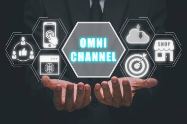 Omni channel concept, Person hand holding omni channel icon on virtual screen. clipart