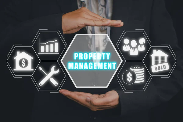 Property management concept, Business person hand holding Property management icon on virtual screen. Real estate, Efficiency rating and property value.