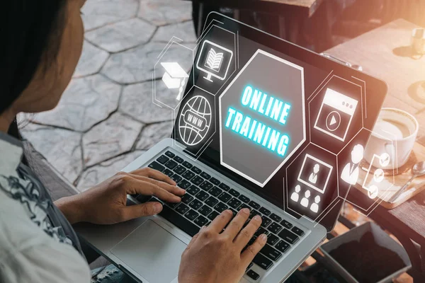 Online training concept, Person using laptop computer with online training icon on virtual screen.