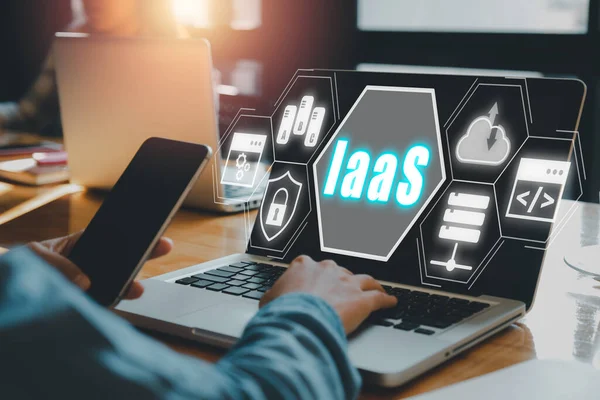 IaaS - Infrastructure as a service, Business woman hand using laptop computer with Infrastructure as a Service icon on VR screen, networking and application platform. Internet and technology concept.
