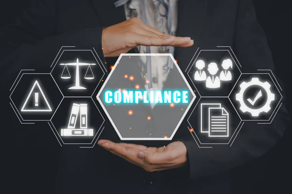 Compliance Rules Law Regulation Policy Business Technology concept, Business woman hand holding compliance icon on virtual screen.