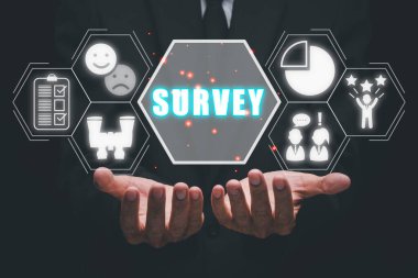 Survey concept, Business person hand holding survey icon on virtual screen. clipart