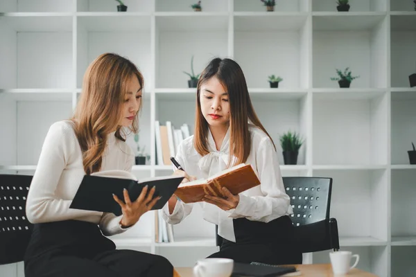 stock image Two diverse serious businesswomen discussing business project working together in office, serious female advisor and client talking at meeting