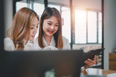 Female operations manager holds meeting presentation for a team of economists. Asian woman uses business paper with Growth Analysis, Charts, Statistics and Data.	