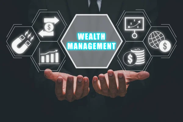 Wealth management concept, Businessman hand holding wealth management icon on virtual screen.