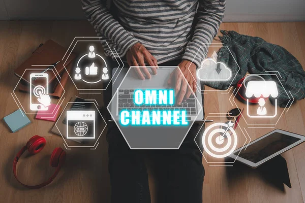 Omni channel concept, Person using laptop computer with omni channel icon on virtual screen.