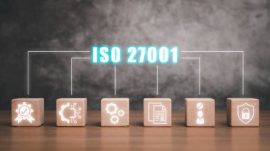 Iso 27001 concept, Wooden block on desk with iso 27001 icon on virtual screen. clipart