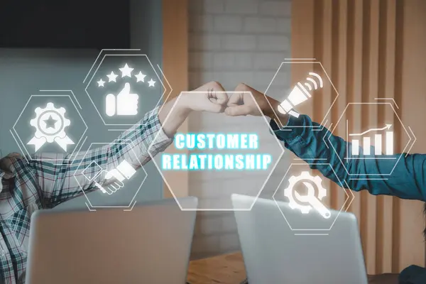 Customer relationship concept, Business team giving fist bump after complete deal on office with customer relationship icon on virtual screen.
