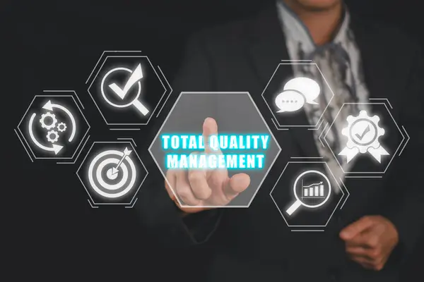 Total quality management concept, Business woman hand touching total quality management icon on virtual screen.