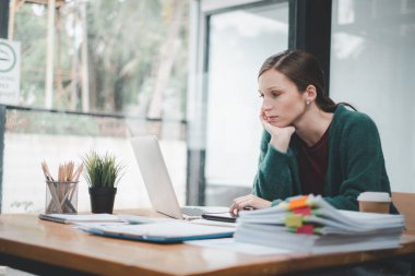 Woman stressed while working on laptop, Tired businesswoman with headache at office, feeling sick at work, copy space.	