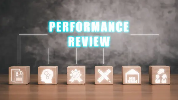 Performance review concept, Wooden block on desk with performance review icon on virtual screen.