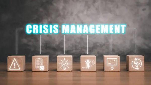 Crisis management concept, Wooden block on desk with crisis management icon on virtual screen.