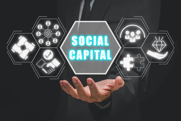 Social capital concept, Businessman hand holding social capital icon on virtual screen.