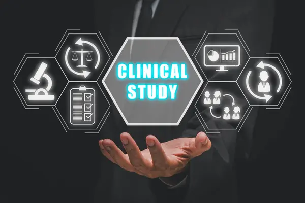 Clinical study concept, Businessman hand holding clinical study icon on virtual screen.